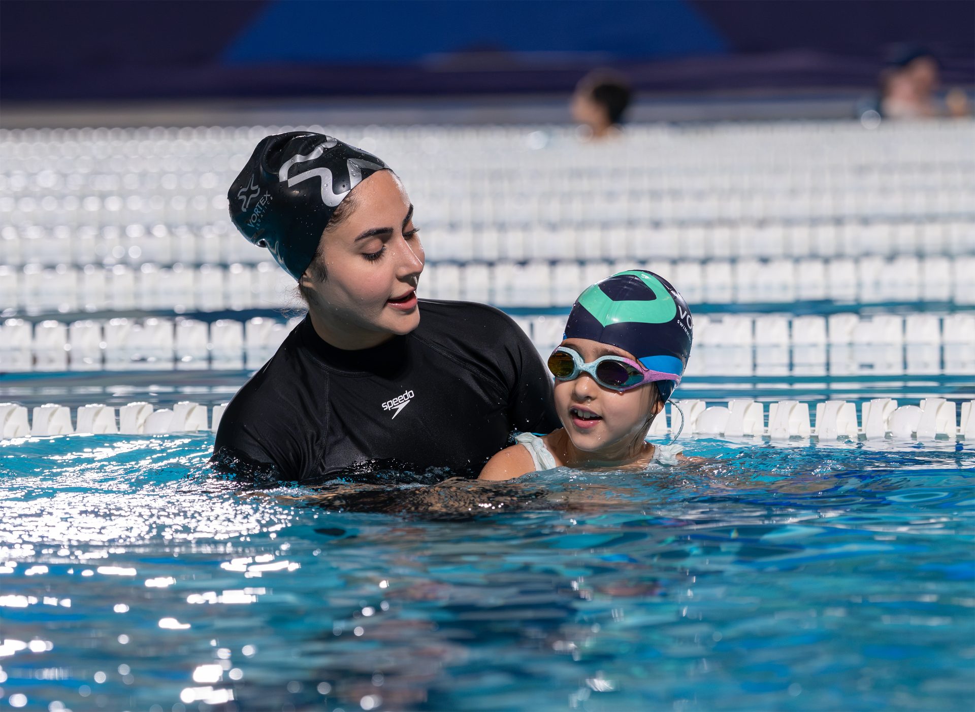 A coach teaching a swimmer in a lesson
