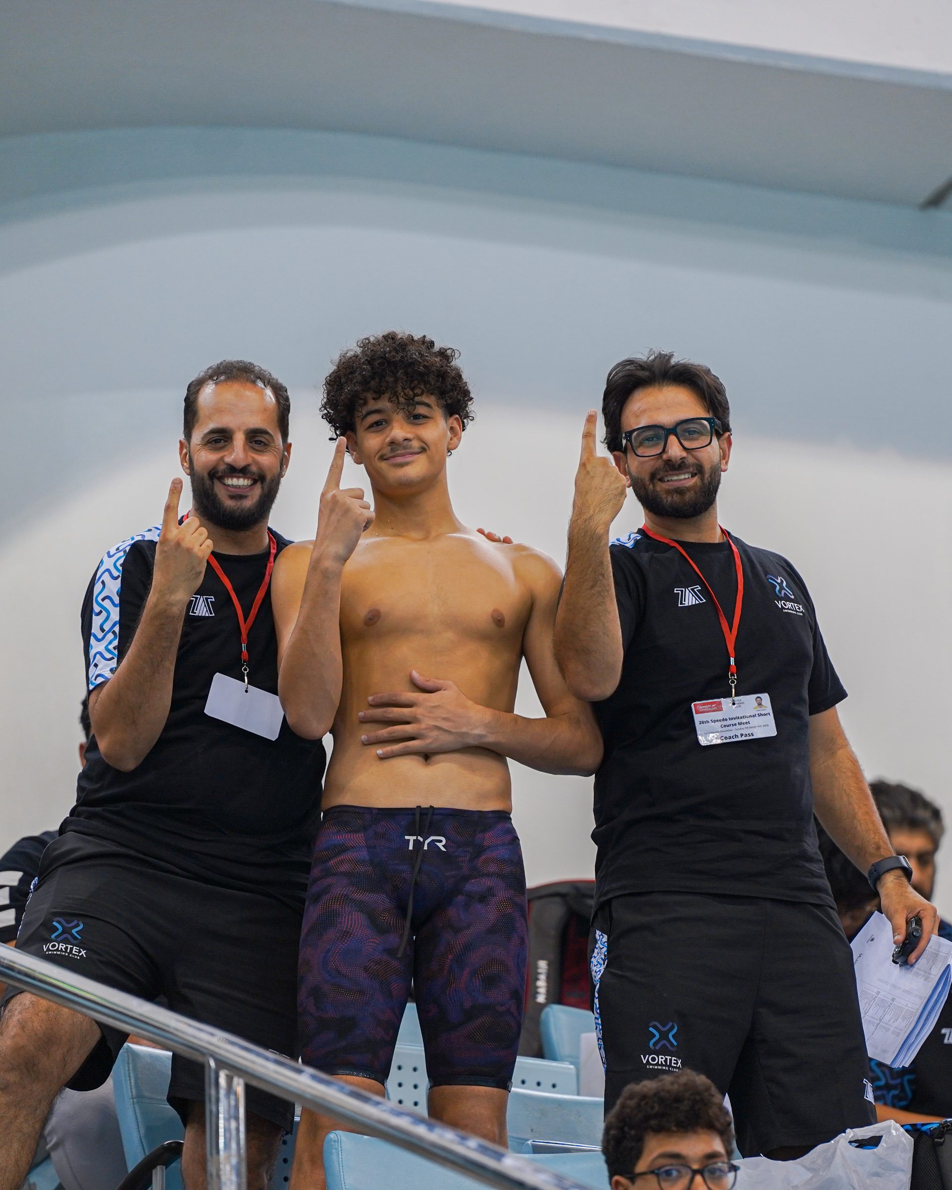 Coaches celebrating with a winning swimmer