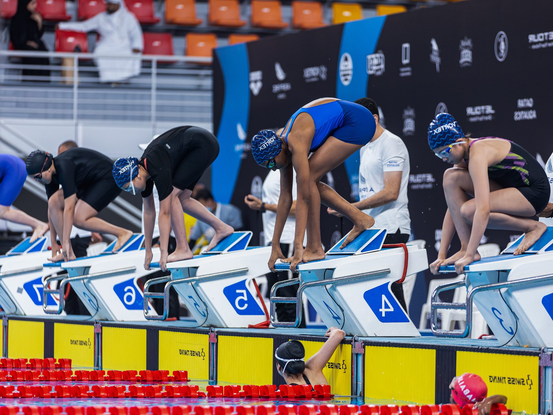Young swimmers on the starting blocks at a competition